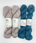 Three skeins of yarn, two blue and one gray, with labels on a white background.