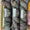 Three skeins of Ex Libris variegated yarn stacked vertically, featuring a dark charcoal gray and black base with subtle hints of olive green and muted burgundy. Each skein is wrapped in a black paper band displaying the Ex Libris logo.