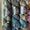 Six skeins of variegated yarn from Ex Libris, arranged in two rows on a rustic wooden surface. The yarn features variegated colors of slate blue, charcoal gray, black, and hints of olive green and gold.